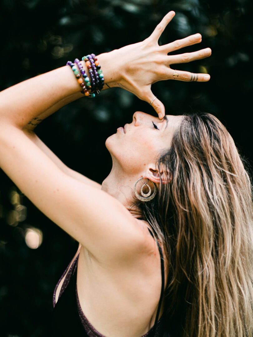 Woman in graceful yoga pose with bracelets